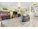 View of the living room with piano, TV, and wood flooring at 7 Sturm St, Henderson, NV 89015