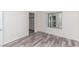 Cozy bedroom featuring wood-look floors and access to a walk-in closet for added convenience at 7100 Pirates Cove Rd # 2065, Las Vegas, NV 89145