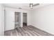 Clean bedroom with wood-look floors, and a view of the en-suite bathroom and closet at 7100 Pirates Cove Rd # 2065, Las Vegas, NV 89145