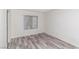 Inviting bedroom with wood-look floors and a window offering a pleasant view of the outdoors at 7100 Pirates Cove Rd # 2065, Las Vegas, NV 89145