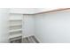 Organized walk-in closet providing ample storage with shelving and a hanging rod at 7100 Pirates Cove Rd # 2065, Las Vegas, NV 89145