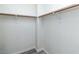A walk-in closet features two metal bars for clothing storage and contemporary neutral paint at 7100 Pirates Cove Rd # 2065, Las Vegas, NV 89145