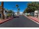 Neighborhood entrance features mature trees, gated entry, and well-maintained landscaping at 7100 Pirates Cove Rd # 2065, Las Vegas, NV 89145