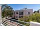 Apartment exterior with green railings on balcony and mature trees around the property at 7100 Pirates Cove Rd # 2065, Las Vegas, NV 89145