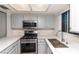 Updated kitchen featuring stainless steel appliances, light gray cabinetry, and white marble countertops at 7100 Pirates Cove Rd # 2065, Las Vegas, NV 89145