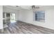 This is a living area with laminate flooring, a sliding glass door to the patio, and neutral paint at 7100 Pirates Cove Rd # 2065, Las Vegas, NV 89145