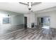 Bright living room featuring wood-look floors, a fireplace, and a mirrored wall for added space at 7100 Pirates Cove Rd # 2065, Las Vegas, NV 89145
