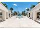 A community pool area has ample lounge chairs, covered seating, palm trees and clear blue skies at 7100 Pirates Cove Rd # 2065, Las Vegas, NV 89145