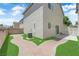 Backyard features a brick sidewalk, grass, and air conditioning unit at 7257 Early Pioneer Ave, Las Vegas, NV 89129