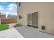 Backyard featuring a sliding glass door, patio, brick sidewalk, and grass at 7257 Early Pioneer Ave, Las Vegas, NV 89129