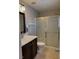Bathroom featuring a vanity with a sink, a mirror, a toilet, and a glass-enclosed shower at 7257 Early Pioneer Ave, Las Vegas, NV 89129