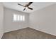 This sunny bedroom features plush carpeting, window shutters, and ceiling fan at 7257 Early Pioneer Ave, Las Vegas, NV 89129