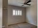 Bedroom featuring neutral walls, carpeted floor, ceiling fan, and a window with white shutters at 7257 Early Pioneer Ave, Las Vegas, NV 89129