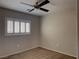 Neutral toned bedroom featuring a ceiling fan, carpeted floor and a window with white shutters at 7257 Early Pioneer Ave, Las Vegas, NV 89129