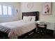 Bright bedroom with a study area, featuring a desk and white cushioned rolling chair with a comfortable bed at 7257 Early Pioneer Ave, Las Vegas, NV 89129