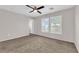 This bright bedroom features large windows and a ceiling fan at 7257 Early Pioneer Ave, Las Vegas, NV 89129