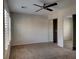 This bedroom features a ceiling fan, carpeted floor, window with shutters and mirrored closet doors at 7257 Early Pioneer Ave, Las Vegas, NV 89129