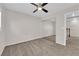 Bedroom with carpet, ceiling fan, mirrored closet doors, and access to landing at 7257 Early Pioneer Ave, Las Vegas, NV 89129