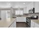 Bright kitchen with white cabinets, stainless steel appliances, and a window with shutters at 7257 Early Pioneer Ave, Las Vegas, NV 89129