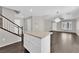 Open-concept kitchen features an island, wood floors, and an open living area at 7257 Early Pioneer Ave, Las Vegas, NV 89129