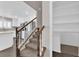 View of kitchen from stairway showcases stainless steel appliances and white cabinetry at 7257 Early Pioneer Ave, Las Vegas, NV 89129