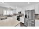 Well-lit kitchen with white cabinets, stainless steel appliances, and ample counter space at 7257 Early Pioneer Ave, Las Vegas, NV 89129