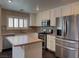 Bright kitchen with stainless steel appliances, island, and mosaic backsplash at 7257 Early Pioneer Ave, Las Vegas, NV 89129