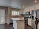 Updated kitchen featuring stainless appliances, island, and wood flooring at 7257 Early Pioneer Ave, Las Vegas, NV 89129