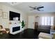 The living room has a fireplace, modern ceiling fan and plantation shutters at 7257 Early Pioneer Ave, Las Vegas, NV 89129