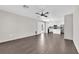 Spacious living room with modern wood-look flooring and ample natural light flowing through large windows at 7257 Early Pioneer Ave, Las Vegas, NV 89129