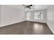 Bright living room with wood-look floors and a ceiling fan at 7257 Early Pioneer Ave, Las Vegas, NV 89129