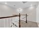 Second floor stairwell with neutral paint, carpet and a dark wood railing at 7257 Early Pioneer Ave, Las Vegas, NV 89129
