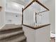 Stairway landing with white railing, carpet, and storage cabinets above laundry area at 7257 Early Pioneer Ave, Las Vegas, NV 89129