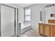Bathroom with a shower, tub, window and vanity at 7870 Midnight Ride St, Las Vegas, NV 89131