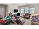 Open living room featuring large windows, patterned sofas and carpeted floor at 7870 Midnight Ride St, Las Vegas, NV 89131
