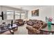 Bright living room with three windows, patterned sofas and comfortable seating at 7870 Midnight Ride St, Las Vegas, NV 89131