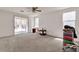 Bright living room features large windows, sliding door and carpeted floor at 7870 Midnight Ride St, Las Vegas, NV 89131