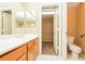 Bathroom with double sinks, a toilet, and an open door to a walk-in closet at 8205 Harrogate Ave, Las Vegas, NV 89129