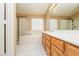 Bright bathroom featuring double sinks, separate shower, and tub with glass block window at 8205 Harrogate Ave, Las Vegas, NV 89129