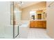 Bright bathroom featuring a double sink, a glass shower, and a large tub at 8205 Harrogate Ave, Las Vegas, NV 89129