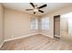 Neutral bedroom with ceiling fan, mirrored closet, and dual windows for natural light at 8205 Harrogate Ave, Las Vegas, NV 89129