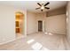 Bright bedroom featuring carpet, a ceiling fan, and access to the ensuite bath at 8205 Harrogate Ave, Las Vegas, NV 89129