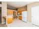 Bright kitchen featuring tile flooring, white appliances, and oak cabinets at 8205 Harrogate Ave, Las Vegas, NV 89129