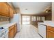 Open kitchen with tile floors, white appliances and access to the backyard at 8205 Harrogate Ave, Las Vegas, NV 89129