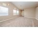 Bright living room with tall ceilings, large windows and neutral walls at 8205 Harrogate Ave, Las Vegas, NV 89129