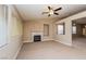 Spacious living room with a fireplace, ceiling fan, and neutral color palette at 8205 Harrogate Ave, Las Vegas, NV 89129