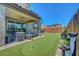 Manicured backyard area featuring a putting green, covered patio, and water feature for outdoor living at 8958 Howell St, Las Vegas, NV 89166