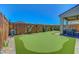 Well-maintained backyard features a putting green, manicured landscaping, and a peaceful water feature at 8958 Howell St, Las Vegas, NV 89166