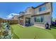 Exterior view of the house featuring putting green, covered patio with outdoor seating and manicured landscaping at 8958 Howell St, Las Vegas, NV 89166