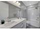Bright bathroom with double sinks, modern fixtures, and a shower-tub combination at 8958 Howell St, Las Vegas, NV 89166